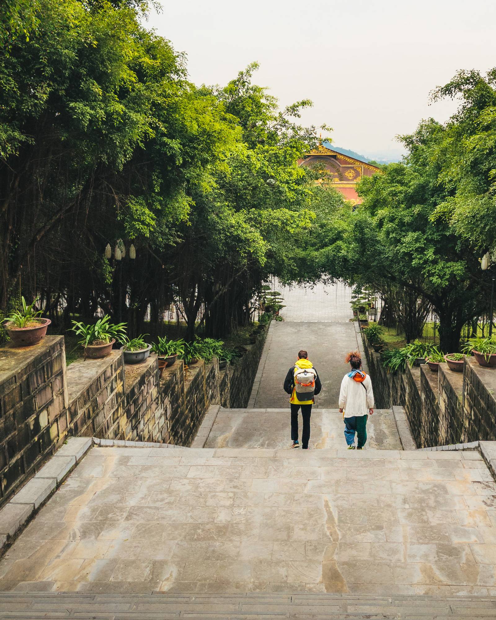 Two guys walking toward a temple in Vietnam