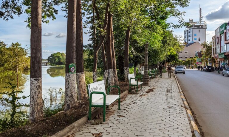 Benches and sidewalk along a river in Battambang