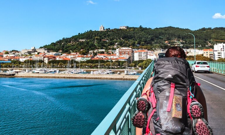 Female pilgrim walking the Camino de Santiago into Viana do Castelo