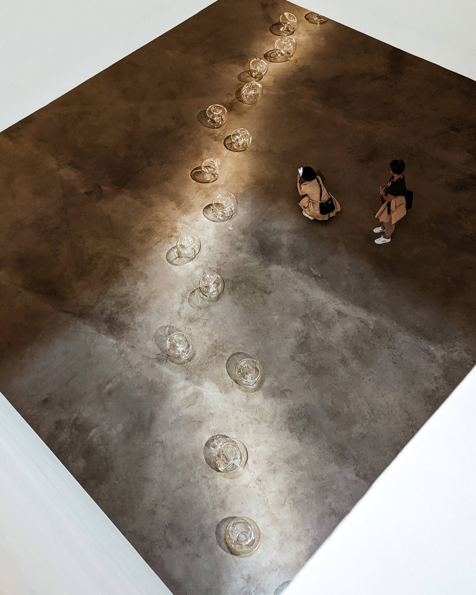 Top down view of a glass bubbles art exhibit at the Bilbao Guggenheim Museum