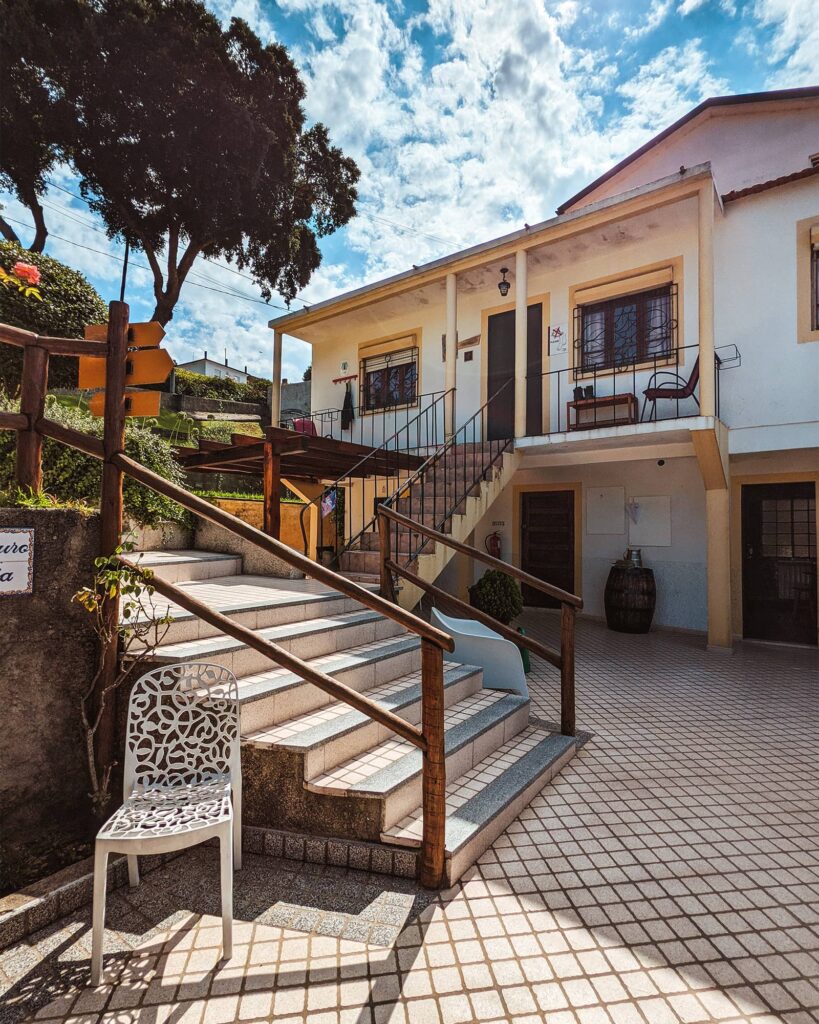 White tile steps that lead up to a door at the back of Albergue Peregrinos St Antonio de Agueda
