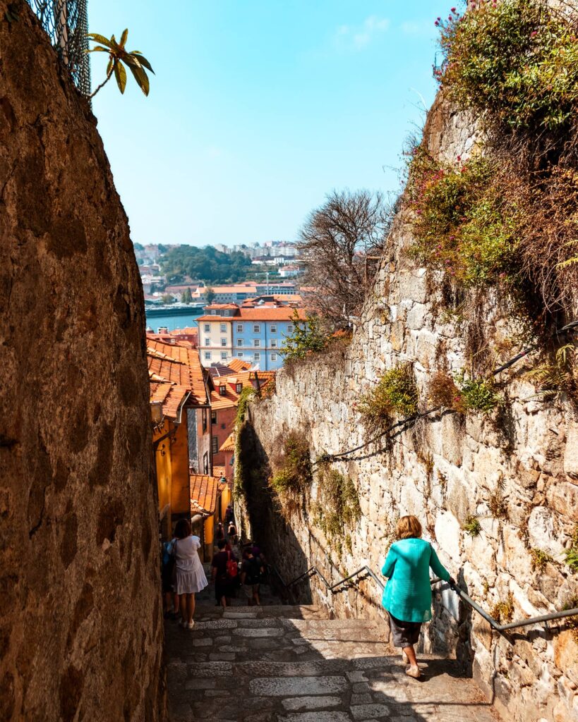 Ladies walking down steep stone steps into the Ribeira neighborhood in Porto